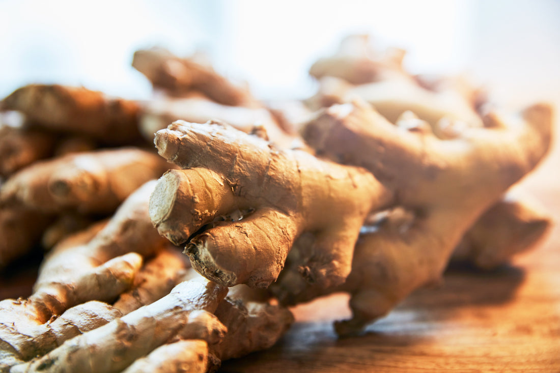 piles of ginger on wooden chopping board
